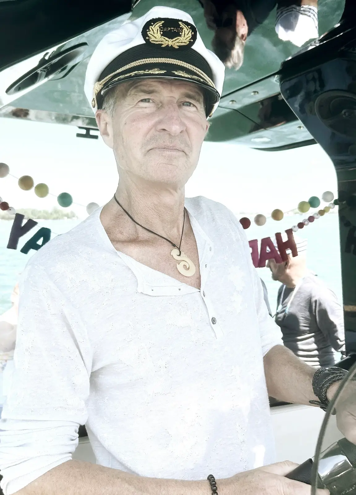 Captain Blair in a white captain's hat aboard the Sycorax