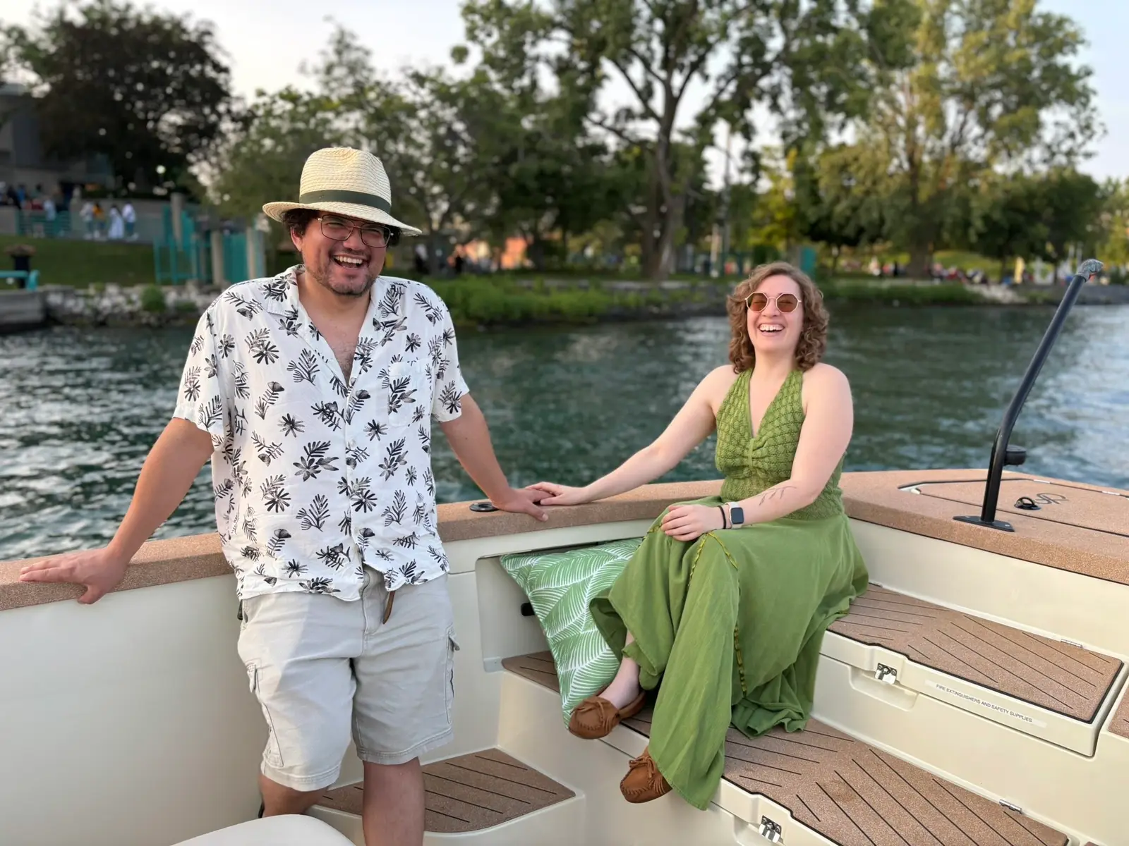 Couple laughing together near Belle Isle during a rehearsal dinner cruise