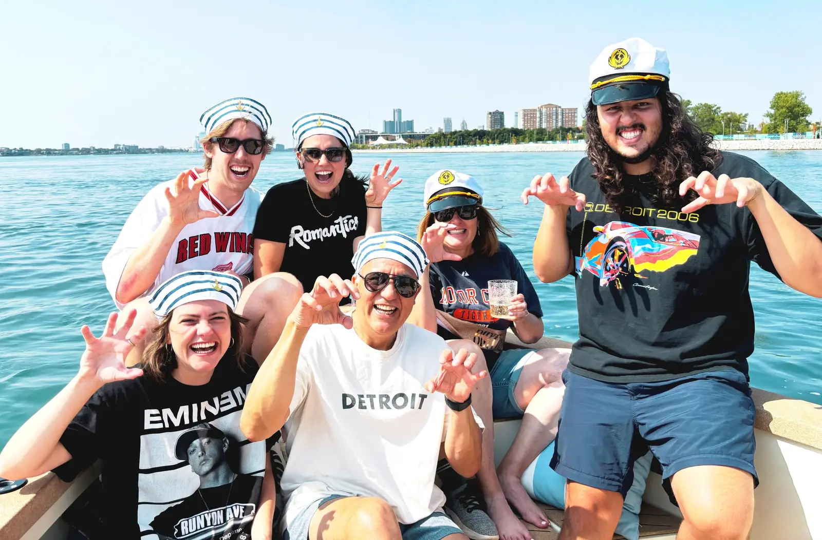 Seven friends in sailor caps celebrating a bachelor party aboard the Sycorax