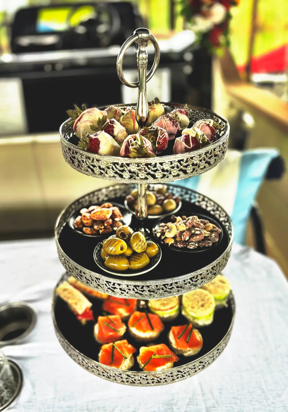 Tiered stand of chocolate-dipped strawberries and canapes for a High Tea cruise